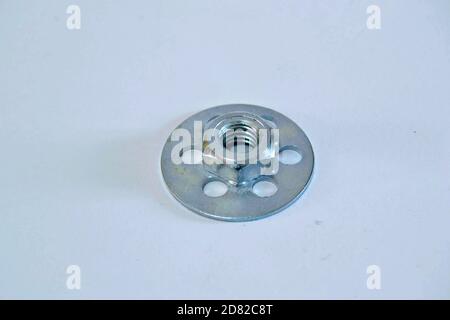 Bonding fastener for composite products. Metric 8 hexagonal nut and base plate with holes in base plate. Stock Photo