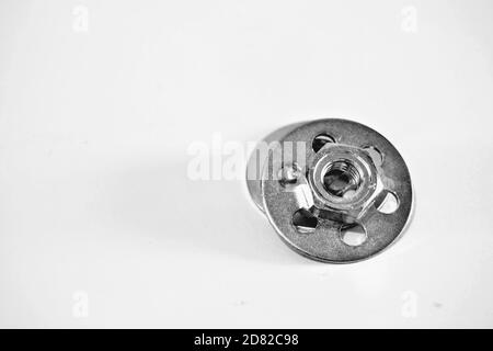 Bonding fastener for composite products. Metric 8 hexagonal nut and base plate with holes in base plate. Stock Photo