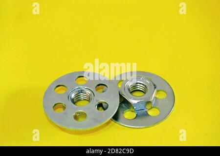 Bonding fastener for composite products. Metric 8 hexagonal nut and base plate with holes in base plate. Stock Photo
