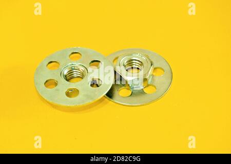 Bonding fastener for composite products. Metric 8 hexagonal nut and base plate with holes in base plate. Stock Photo