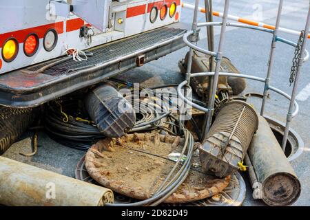 Red and white barriers on the street construction in the city orange safety net for internet or telephone underground cables build ready network. Stock Photo