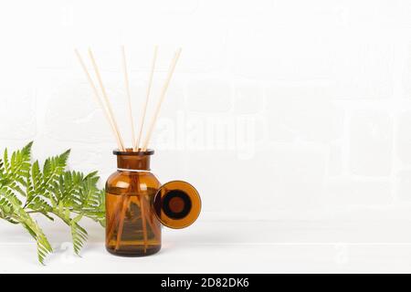 Air refresher bottle mock up, reed diffuser on a white background with fern leaf Stock Photo