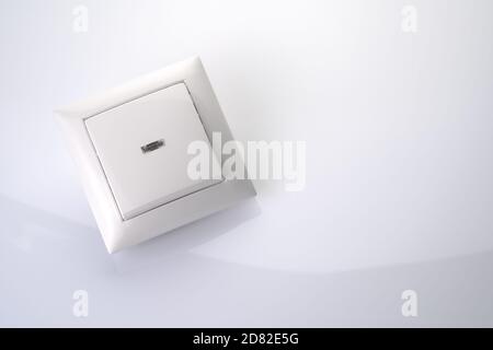 Electric light switch on a light background. Stock Photo