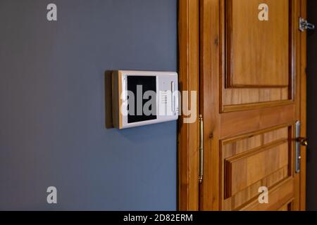 Video intercom display near the entrance door at home close up Stock Photo