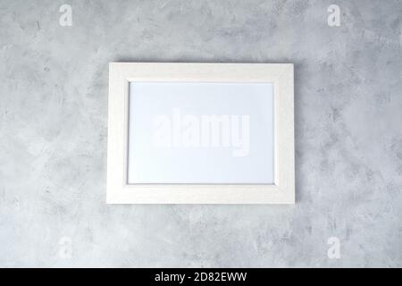 Minimalistic white frame with space for copying, on a concrete background. Stock Photo