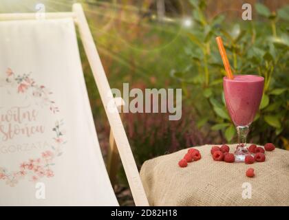 Fresh raspberry smoothie served in a glass dish with a straw. Stock Photo