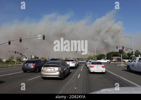 Smoke blows across Irvine Blvd from the Silverado fire in Orange County, Southern California, USA. during strong Santa Ana winds that spread wildfires Stock Photo