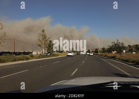 Smoke blows across Irvine Blvd from the Silverado fire in Orange County, Southern California, USA. during strong Santa Ana winds that spread wildfires Stock Photo
