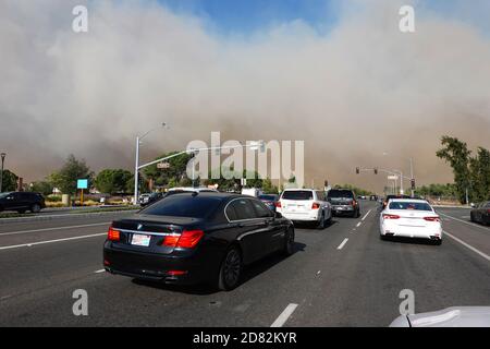 Smoke blows across Irvine Blvd from the Silverado fire in Orange County, Southern California, USA. during strong Santa Ana winds that spread wildfires Stock Photo