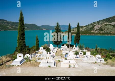 white cemetery on the shores of Lake Kremaston, Greece Stock Photo