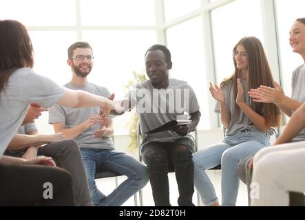 group of young people greeted the speaker with their applause Stock Photo