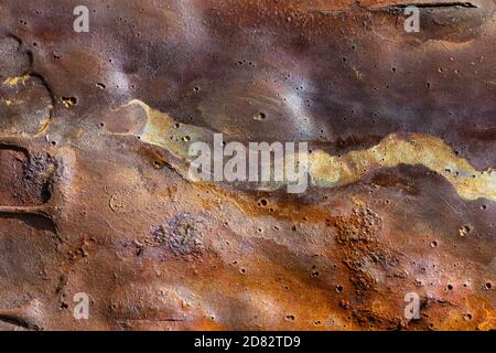background of rusted metal with streaks of yellow and orange Stock Photo