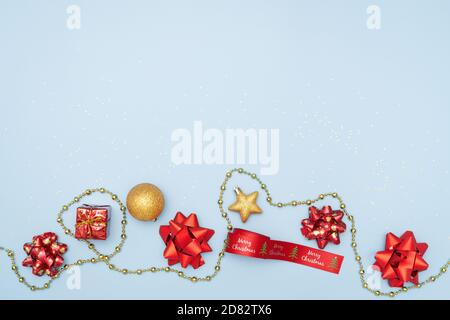 Merry christmas concept, gifts boxes or presents boxes with red bows, star and ball on blue background Stock Photo