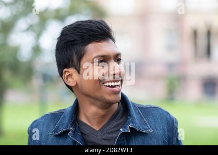 young man laughing outside in the city Stock Photo