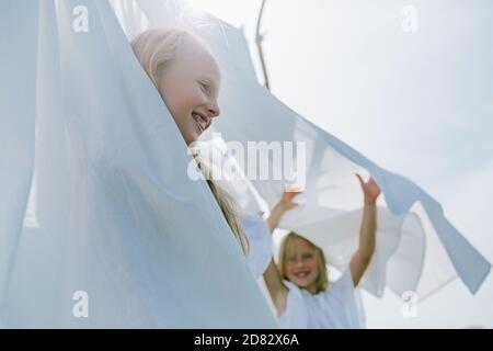 two little girls playing hide and seek Stock Photo