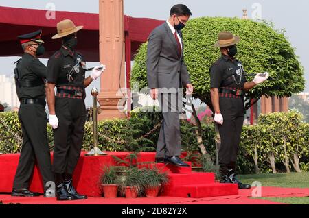 U.S. Defense Secretary Mark Esper wearing a face mask reviews a joint military guard of honour during a ceremonial reception at the Defence Ministry of India.. Stock Photo