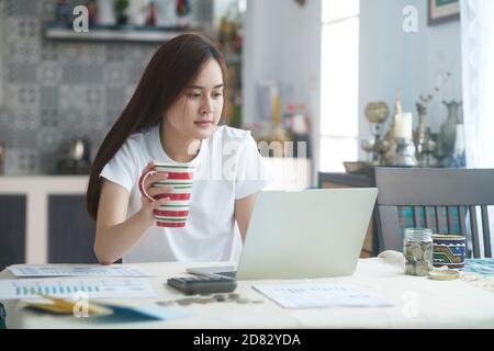 Attractive young Asia woman working at home. working and learning from home. Stock Photo