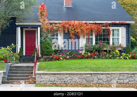 A bright red metal handrail leading up four concrete steps to a walkway. Stock Photo