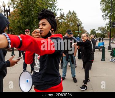 Washington, DC, USA, 26 October,  2020.  Pictured: A female Trump supporter verbally attacks a Black woman protesting against the confirmation of Amy Coney Barrett and in favor of reproductive, civil, and women's rights.    The Trump supporter appeared to be trying to emphasize a point using her wedding ring, but the pro-choice protester was facing the wrong way.  The anti-confirmation protester was one of only a few Black people present and was the target of more intense vitriol from Trump supporters than that they gave white individuals with similar views.  Credit: Allison C Bailey/Alamy Liv Stock Photo