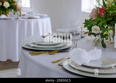 Table set for wedding or another party. Flowers arrangement. Stock Photo
