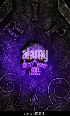 Halloween Rest In Peace Tombstone and Skull Decorating Yard at Night Stock Photo