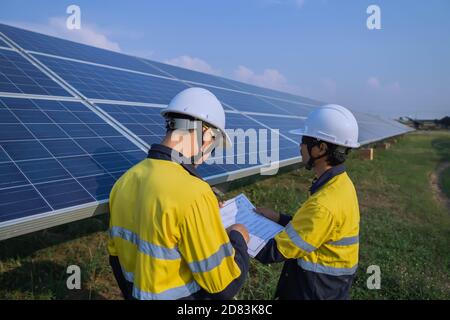 Engineering is checking the accuracy of the solar panel system installation, alternative electricity source, concept of sustainable resources. Stock Photo