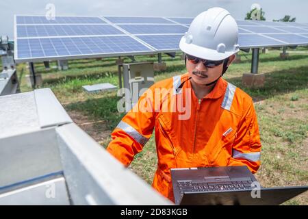 Engineers used a laptop for checking the performance of the controller box to confirming systems working normally. Concepts professional engineer for Stock Photo