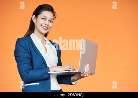 Businesswoman typing on laptop Stock Photo