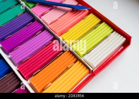 Colorful kid's plasticine on white background, Colorful dough modeling clay.Multicolored briquettes of soft plasticine for modeling with soft focus Stock Photo