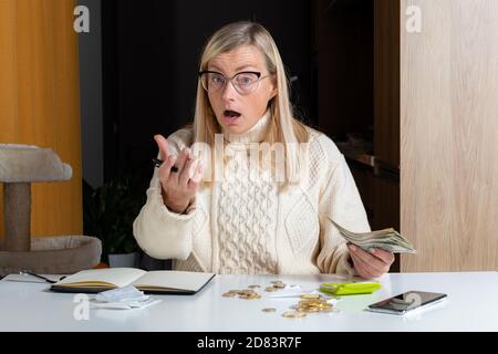 emotional freelance woman calculating budget in home office, expense income and expenses, work from home concept Stock Photo
