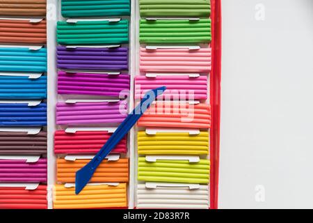 Colorful kid's plasticine on white background, Colorful dough modeling clay.Multicolored briquettes of soft plasticine for modeling with soft focus Stock Photo