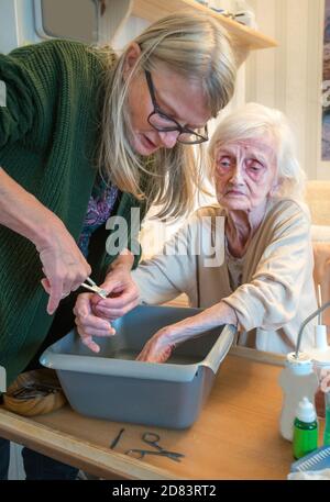 The 92 year old Mother suffers with dementia and macular blindness,she has dirty fingernails due to picking her food, is not in pain but worried that Stock Photo