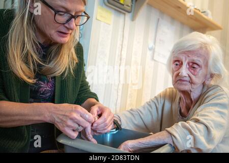 The 92 year old Mother suffers with dementia and macular blindness,she has dirty fingernails due to picking her food, is not in pain but worried that Stock Photo