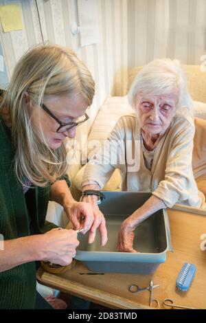 The 92 year old Mother suffers with dementia and macular blindness,she has dirty fingernails due to picking her food, is not in pain but worried that Stock Photo