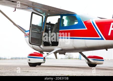 CAEN, FRANCE - JUNE Circa 2016 - Part of small plane on aiport field. CESSNA 172 Blue white Red, with opened door, waiting for customers and pilot Stock Photo