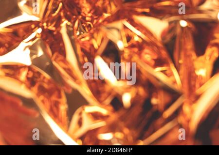 Blurred golden foil shiny texture. Defocused background. Stock Photo