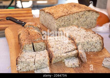 Homemade brown fragrant fresh cereals bread on a rustic wooden board, close up Stock Photo