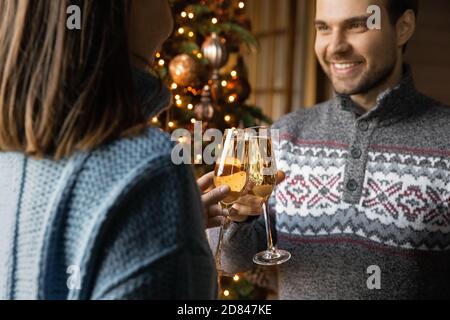 Happy couple clink bottles celebrating New Year Stock Photo