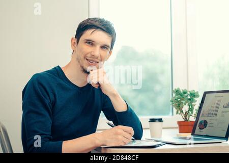 close up. casual young man analyzing financial data . Stock Photo