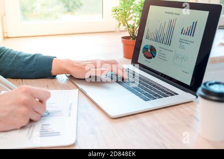 close up. man using his laptop for making financial charts. Stock Photo