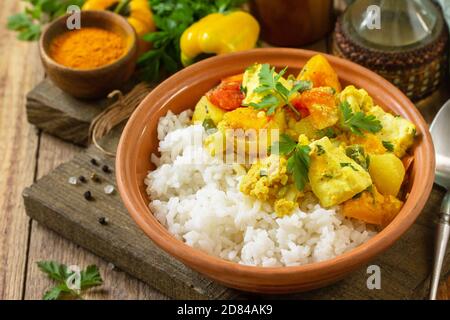 Indian cuisine dish sabji. Traditional Indian vegetable stew with soft cheese and turmeric on a wooden table. Stock Photo