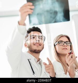two orthopedic doctors looking at the x-ray of the patient Stock Photo