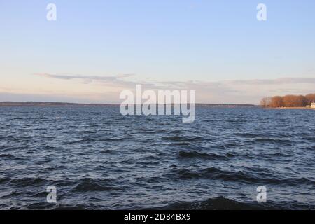 Almost clear blue morning sky and blue water of sea Stock Photo