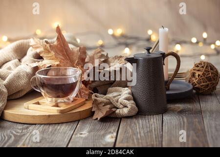 Cozy autumn still life in a homely atmosphere with decorative items. Stock Photo