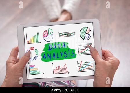 Data analysis concept shown on a tablet held by a woman Stock Photo