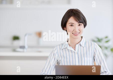 Japanese woman working from home Stock Photo