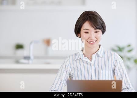 Japanese woman working from home Stock Photo