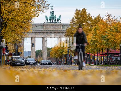 Berlin, Germany. 27th Oct, 2020. Cyclists ride on the street Unter den Linden in front of the Brandenburg Gate. Credit: Fabian Sommer/dpa/Alamy Live News Stock Photo