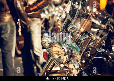 Close Up photo of a Vintage Looking Motorbike. Shiny Steel Vehicle. Bikers Taking a Break from the Road Trip Ride. Active Lifestyle. Stock Photo