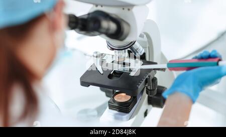 close up. researcher testing the blood under a microscope. Stock Photo
